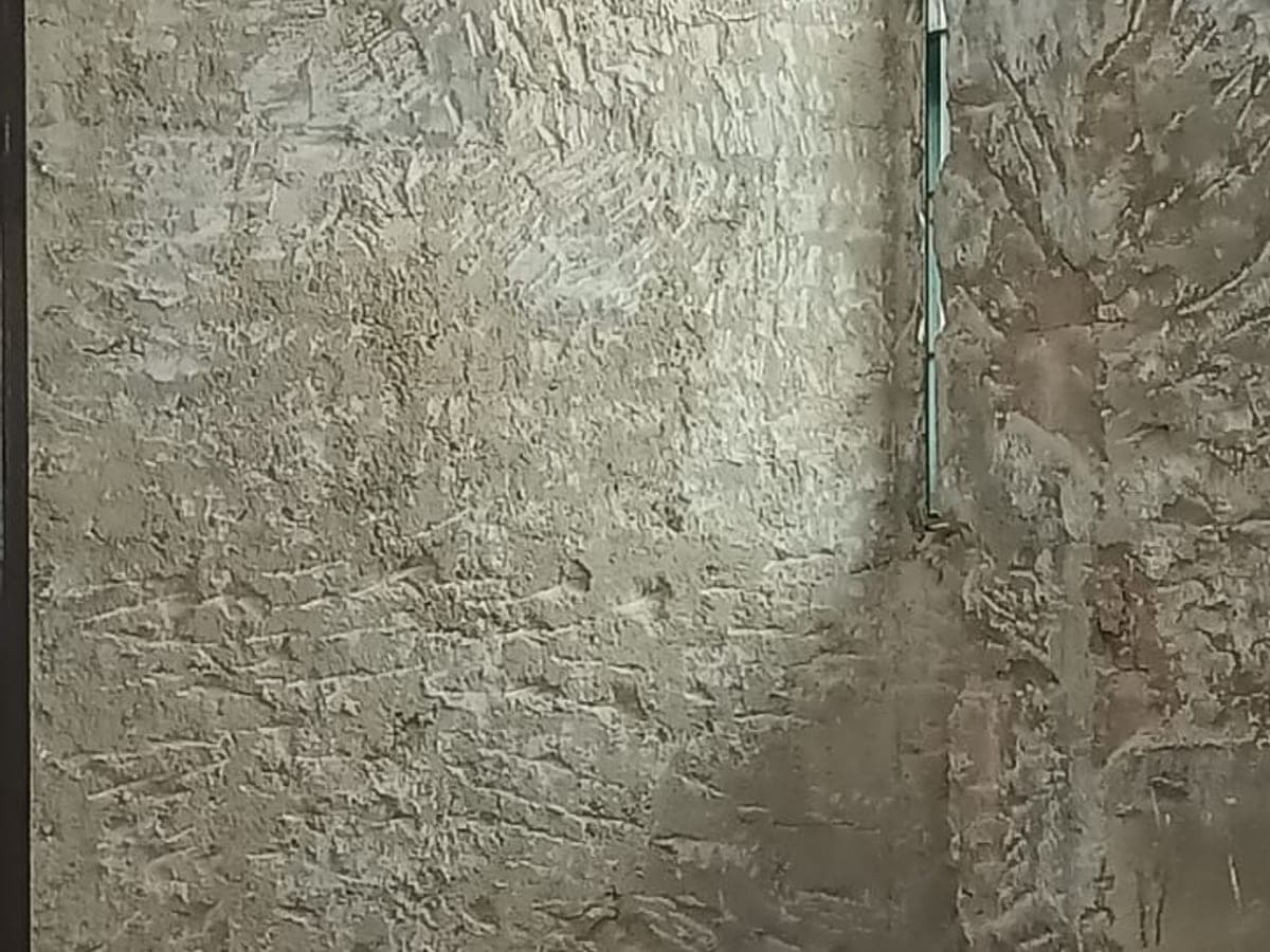 Exposed hacked wall with tools during JBC demo works